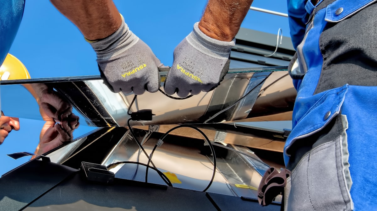 Professional team installing solar panels on residential roof